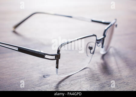 Eyeglasses On Wooden Table With Bright Background Stock Photo