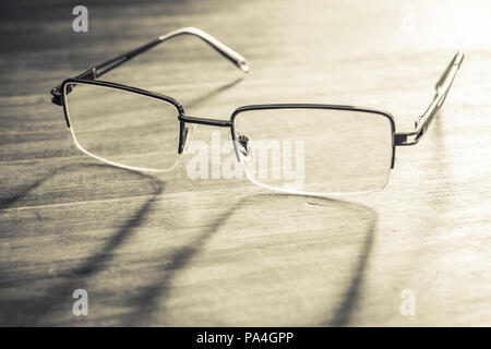 Spectacles On Wooden Table With Bright Background Stock Photo