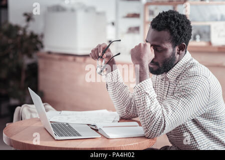 Nice tired man touching his forehead Stock Photo