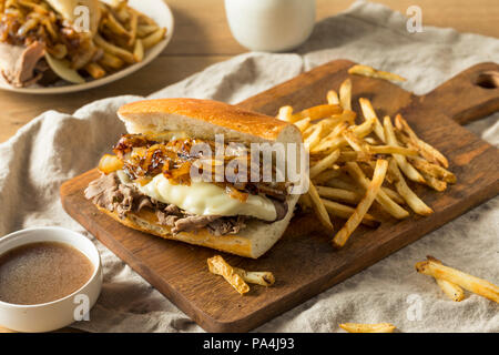 Homemade Beef French Dip Sandwich with French Fries Stock Photo
