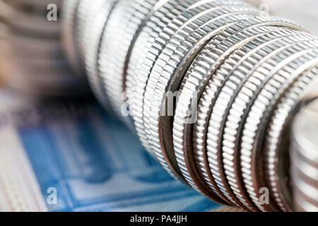 Steel coins lying on the side of the body together in a large pile, closeup and a shallow depth of field Stock Photo