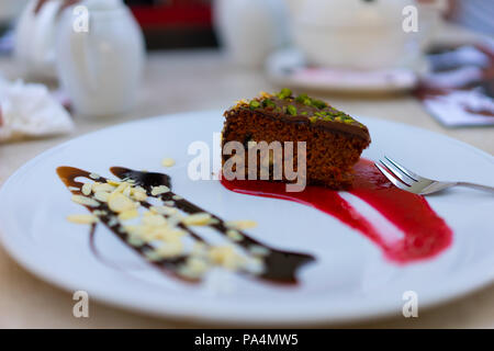 Polish style chocolate carrot cake with Almonds strawberry and chocolate swirl. Stock Photo