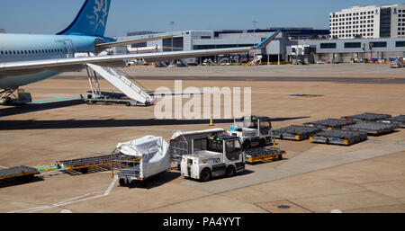 equipment to handle passenger baggage on the apron at London Gatwick Airport
