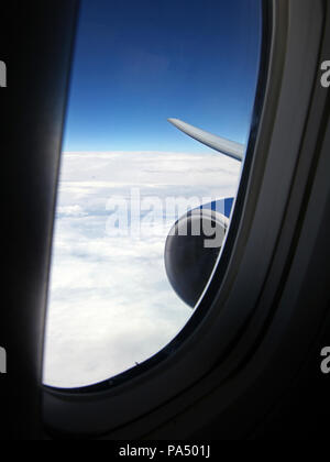 view from a Bowing jet through a side window towards the wing tip Stock Photo