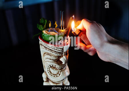 Alcoholic cocktail with mint and lime with fire in originally voodoo Alcoholic cocktail with mint and lime with fire in originally voodoo