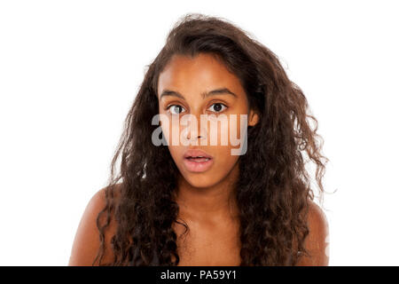 Shocked dark skinned young girl on white background