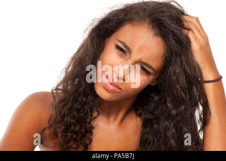 young dark skinned girl has itching in her hair Stock Photo