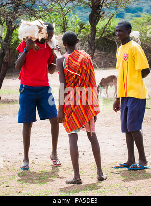 AMBOSELI, KENYA - OCTOBER 10, 2009: Unidentified Massai people with wooden sticks talking about something in Kenya, Oct 10, 2009. Massai people are a  Stock Photo
