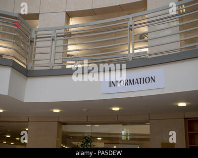 Plain information sign hanging in a large, modern room  Stock Photo