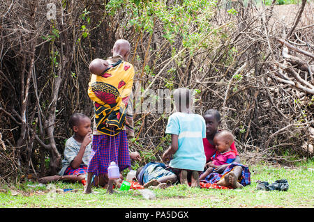AMBOSELI, KENYA - OCTOBER 10, 2009: Unidentified Massai people in Kenya, Oct 10, 2009. Massai people are a Nilotic ethnic group Stock Photo