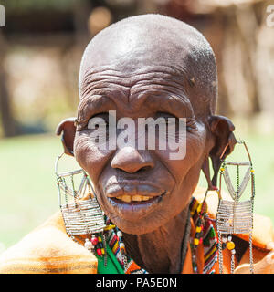 AMBOSELI, KENYA - OCTOBER 10, 2009: Portrait of an unidentified Massai extraordinary woman with heavy earings in Kenya, Oct 10, 2009. Massai people ar Stock Photo