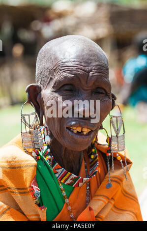 AMBOSELI, KENYA - OCTOBER 10, 2009: Portrait of an unidentified Massai extraordinary woman with heavy earings in Kenya, Oct 10, 2009. Massai people ar Stock Photo
