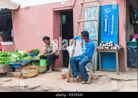 ANTANANARIVO, MADAGASCAR - JUNE 29, 2011: Unidentified Madagascar man and woman work at the market. People in Madagascar suffer of poverty due to the  Stock Photo