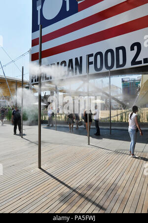 MILAN, ITALY – 06 30 2015:  An example of the use of vaporized water jets, used to refresh people during the hottest hours of the day in visiting plac Stock Photo