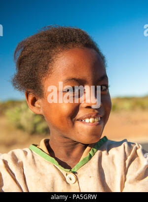 MADAGASCAR - JULY 3, 2011: Portrait of an unidentified smiling girl in the field of Madagascar, July 3, 2011. Children of Madagascar suffer of poverty Stock Photo