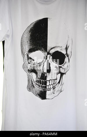 Artwork design based on a human skull, printed on a tee shirt on sale at the market in Beziers, France Stock Photo