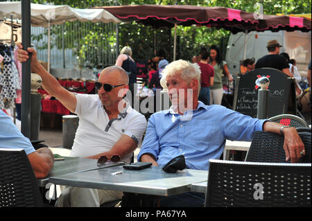 Two elderly men sitting at the cafe in the market held each week in Beziers, France Stock Photo