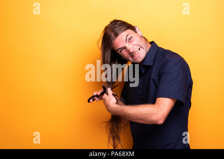 Funny face man cutting hair Stock Photo