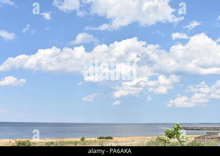 Beautiful seascape with blue sky and fluffy white cumulus clouds Stock Photo