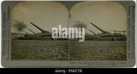 . English: Horizontal, sepia stereocard showing four railroad artillery pieces in a field firing at a target out of view. Keystone Stereograph number V19267. The title reads: ' 'The dogs of war let loose are howling' - French 320's in Action, near Reims.' Title: 'French 320's Defending Reims.' . between circa 1914 and circa 1918 3 &quot;French 320's Defending Reims.&quot; Stock Photo