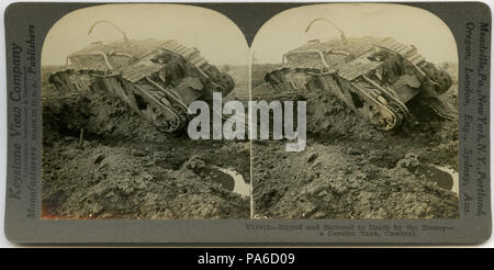 . English: Horizontal, sepia stereocard showing a ruined tank with damage visible in multiple areas located in a muddy field. Keystone Stereograph number V18918. The title reads: 'Ripped and Battered to Death by the Enemy - a Derelict Tank, Cambrai.' Title: 'A Derelict Tank Near Cambrai.' . between circa 1914 and circa 1918 1 &quot;A Derelict Tank Near Cambrai.&quot; Stock Photo