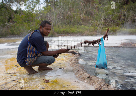 Fergusson Island locals cooking food on natural Hot Springs, Papua New Guinea Stock Photo