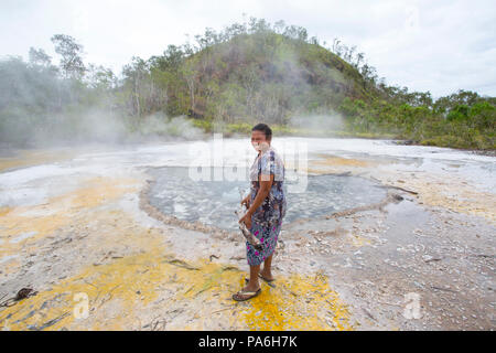 Fergusson Island locals cooking food on natural Hot Springs, Papua New Guinea Stock Photo