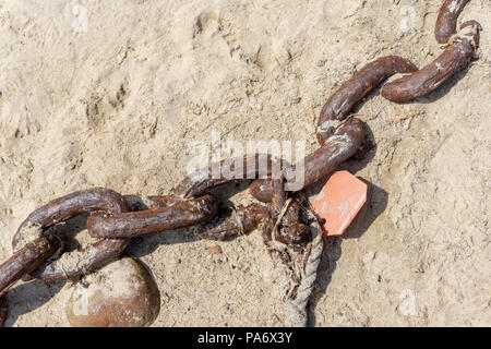 Old rusty mooring chain at the harbor in Mousehole, Cornwall UK Stock Photo