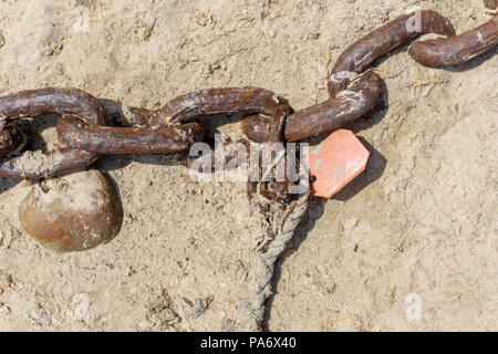 Old rusty mooring chain at the harbor in Mousehole, Cornwall UK Stock Photo