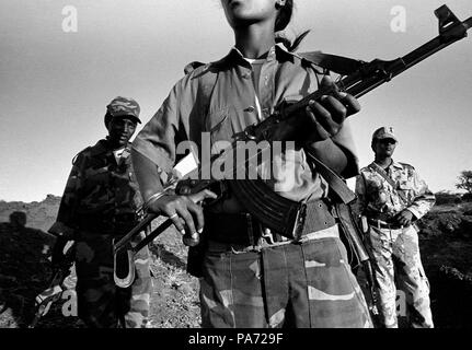 Tserona, Eritrea. 2nd Nov, 1999. GENET KAHSAI (C), ALGANESH TSEGEZEAB (L) and AYNOUM TESFAMICHAEL stand at a trench near the border they defend at Egri Mikhal. Women comprise one third of the military and fight alongside the men. Credit: Cheryl Hatch/ZUMAPRESS.com/Alamy Live News Stock Photo