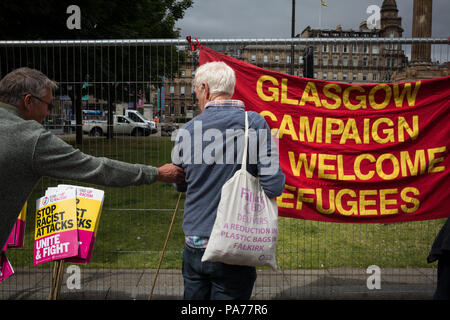 Glasgow, Scotland, on 21 July 2018. A counter demonstration by United Against Facism supporters, during a protest by the far right Scottish Defence League, in George Square, Glasgow, Scotland.  Mounted police and police with dogs separated the two groups as the Scottish Defence League espoused their anti-immigrant rhetoric and accused immigrants of running grooming gangs. Image credit: Alamy News. Stock Photo