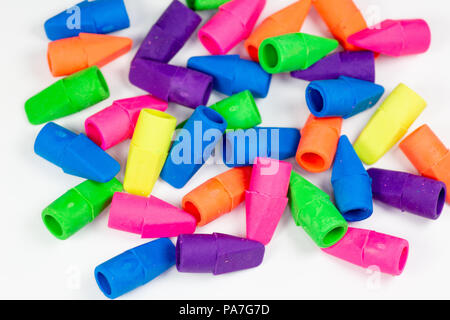 Colorful pencil erasers cluttered on a white surface Stock Photo