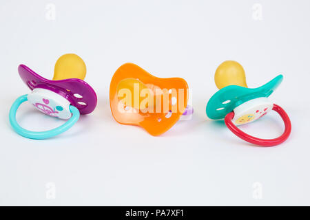 Three Cute Baby pacifiers with rubber head isolated on white background Stock Photo