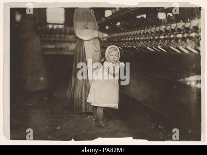 Ivey Mill, Hickory, N.C. Little one, 3 years old, who visits and plays in the mill. Daughter of the overseer. Artist: Lewis Hine (American, 1874-1940). Dimensions: Image: 11.7 x 16.9 cm (4 5/8 x 6 5/8 in.). Date: November 1898.  Trained as a sociologist at Columbia University, Hine gave up his New York City teaching job in 1908 to become a full-time photographer for the National Child Labor Committee.  Created four years earlier, the reform agency's success was largely dependent on its ability to sway public opinion.  Influenced by Jacob Riis's pictures of slum conditions on New York's Lower E Stock Photo