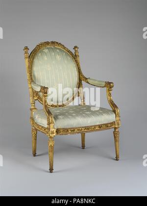Armchair (Fauteuil à la reine). Culture: French, Paris. Dimensions: H. 38-3/4 x W. 26-3/8 x D. 23-5/8 in.  (98.4 x 67.0 x 60.0 cm). Maker: attributed to Georges Jacob (French, Cheny 1739-1814 Paris). Date: ca. 1785.  This armchair with a medallionshaped back surmounted by a rippled bowknot, its columnar uprights surmounted by finials shaped like flaming cassolettes, seems to be depicted in two paintings by Adelaide Labille-Guiard (1749-1803). Principal painter to 'Mesdames Tantes,' the unmarried aunts of Louis XVI, Labille-Guiard exhibited a full-length portrait of Madame Adelaide at the Salon Stock Photo