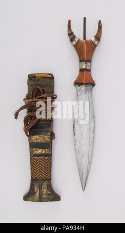 Dagger with Sheath. Culture: Philippine, Mandaya. Dimensions: L. with sheath 13 9/16 in. (34.4 cm); L. without sheath 12 in. (30.5 cm); W. 2 7/16 in. (6.2 cm); Wt. 4 oz. (113.4 g); Wt. of sheath 2.9 oz. (82.2 g). Date: 19th century. Museum: Metropolitan Museum of Art, New York, USA. Stock Photo