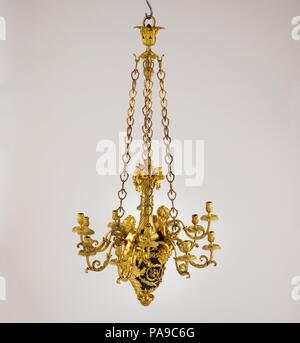 Twelve-light chandelier (lustre). Culture: French, Paris. Dimensions: H. 55 in.  (139.7 cm); Diam. 28 1/2 in. (72.4 cm). Maker: Attributed to Pierre Rémond (French, Paris 1747-1812 Paris). Date: ca. 1785.  The metal body of this graceful chandelier is composed of a vase fitted with a slender, spiral-fluted neck of gilt bronze, topped by an arrangement of various fruits. Two pairs of S-shaped candle branches emerge from the folded arms of two beautifully modeled female half-figures evolving from acanthus leaves, while additional branches spring from between the horns of two satyr masks. The com Stock Photo