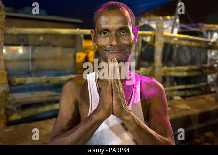 Amazing portrait of Hindu man joining hands at night during Durga puja celebration in Kolkata, India Stock Photo