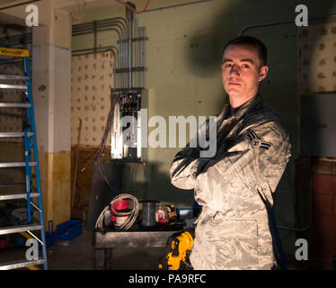 Airman 1st Class Joshua Sprinkles, a 354th Civil Engineer Squadron electrical technician, takes a break from installing electrical metallic conduit and wires in Amber Hall on March 3, 2016, at Eielson Air Force Base, Alaska. Preparing for an influx of Airmen in anticipation of the future basing of the F-35 Lightening II at Eielson, the 354th CES and contractors are remodeling offices to support missions across the U.S. Pacific Air Forces area of responsibility. (U.S. Air Force photo by Staff Sgt. Shawn Nickel/Released) Stock Photo