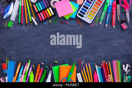 School And Office Supplies On Blackboard Stock Photo
