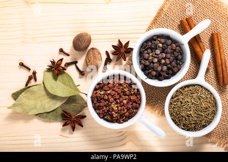 Exotic spices concept Chinese Asian Spices mix  Sichuan peppercorns, star anise pods, bay leave, black peppers, nutmegs, cloves and cinnamon sticks wi Stock Photo