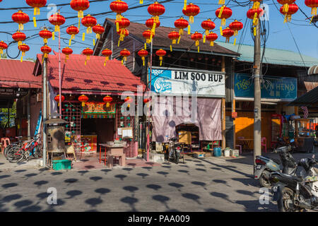 Shop, temple and restaurant fronts in a Chinese fishing village on West Coast of Penang, Malaysia Stock Photo