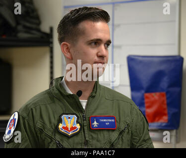 Brendan Lyons, Tucson community hometown hero, listens to a briefing about the aircrew flight equipment he will be using during a flight in a U.S. Air Force Air Demonstration Squadron Thunderbird, an F-16 Fighting Falcon, at Davis-Monthan Air Force Base, Ariz., March 11, 2016.  Lyons was nominated as a hometown hero because of his commitment to safety and his passion to make Tucson a safer community for cyclists and motorists. (U.S. Air Force photo by Senior Airman Chris Massey/Released) Stock Photo