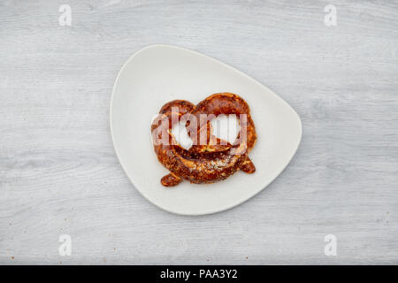 pretzel on white plate Stock Photo