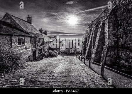 Black & White of famous Gold Hill in Shaftesbury with sun in sky taken in Shaftebury, Dorset, UK on 3 January 2017 Stock Photo