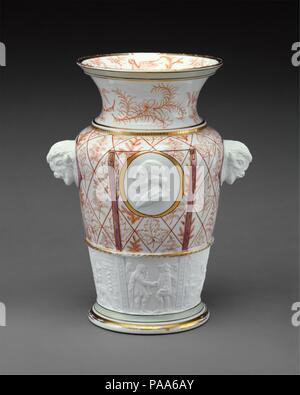 Century Vase. Culture: American. Designer: Designed by Karl L. H. Müller (ca. 1820-1887). Dimensions: H. 12 3/4 in. (32.4 cm). Manufacturer: Manufactured by Union Porcelain Works (1863-ca. 1922). Date: ca. 1876.  Nationalistic motifs embellish this pair (see 69.194.2) of vases designed by sculptor Karl Müller in honor of America's 1876 Centennial. Native American plants decorate the body and North American bison heads serve as handles. A profile portrait of George Washington embellishes each side, and the six biscuit relief panels around the base each depict scenes from American history - amon Stock Photo