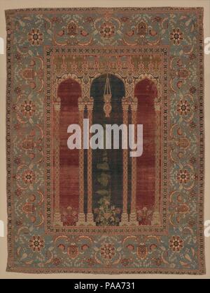 Carpet with Triple-Arch Design. Dimensions: Rug: L. 68 in. (172.7 cm)   W. 50 in. (127 cm)  Mount: L. 71 in. (180.3 cm)   W. 53 3/4 in. (136.5 cm)   D. 3 5/8 in. (9.2 cm)   Wt. 120 lbs. (54.4 kg). Date: ca. 1575-90.  This carefully drawn, subtly colored carpet is among the finest of all Ottoman weavings. One of the earliest carpets to include a triple-arched gateway, its design probably originated in the Ottoman imperial workshop. The hanging lamp in the center arch recalls verses from the Qur'an that liken God to the light of a lamp, placed within a niche. The combination of this carpet's ima Stock Photo