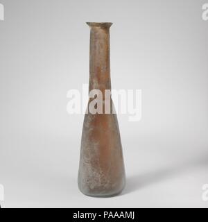 Glass perfume bottle. Culture: Roman. Dimensions: H.: 7 11/16in. (19.5cm)  Diam.: 2 1/8in. (5.5cm). Date: 3rd century A.D..  Colorless with blue green tinge.  Plain, rounded rim; flaring mouth; cylindrical neck, expanding downward and tooled in around base; elongated conical body with convex sides; flat bottom.  Intact; some bubbles; dulling, with patches of pitting and iridescent weathering. Museum: Metropolitan Museum of Art, New York, USA. Stock Photo
