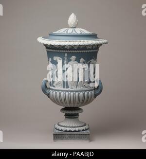 Urn with cover. Culture: British, Etruria, Staffordshire. Dimensions: Height (with cover): 18 5/8 in. (47.3 cm). Factory: Josiah Wedgwood (British, Burslem, Stoke-on-Trent 1730-1795 Burslem, Stoke-on-Trent). Modeler: Jan (or Jean) de Vaere (or Devaere) (Flemish, 1754-1830). Date: ca. 1780-1800, with later base.  This urn reflects Wedgwood's adaptation of the Borghese Vase, a monumental marble vase produced in Greece in the 1st century B.C.  Discovered in Rome in 1566, it became a source of inspiration for European artists. Museum: Metropolitan Museum of Art, New York, USA. Stock Photo