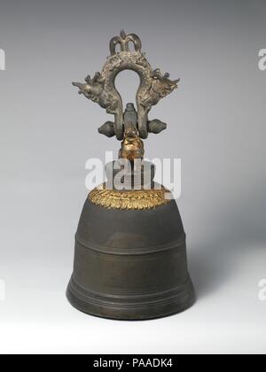 Bell. Culture: Burmese. Dimensions: Height: 27 in. (68.6 cm)  Diameter: 15 1/2 in. (39.4 cm)  Weight: 1855.2 oz. (52.6 kg). Date: 1879.  Cast in Shwebo, a town north of Mandalay, this monastery bell weighs approximately one hundred and fifty pounds and is part of an ancient tradition of elaborately adorned clapperless bronze hanging temple bells found throughout Southeast Asia and Indonesia.  The support mounts, attached above a stylized and gilded double lotus design appearing on the bell's shoulder, take the form of two guardian  simbas (mythical lions), while the suspension loop is cast to  Stock Photo